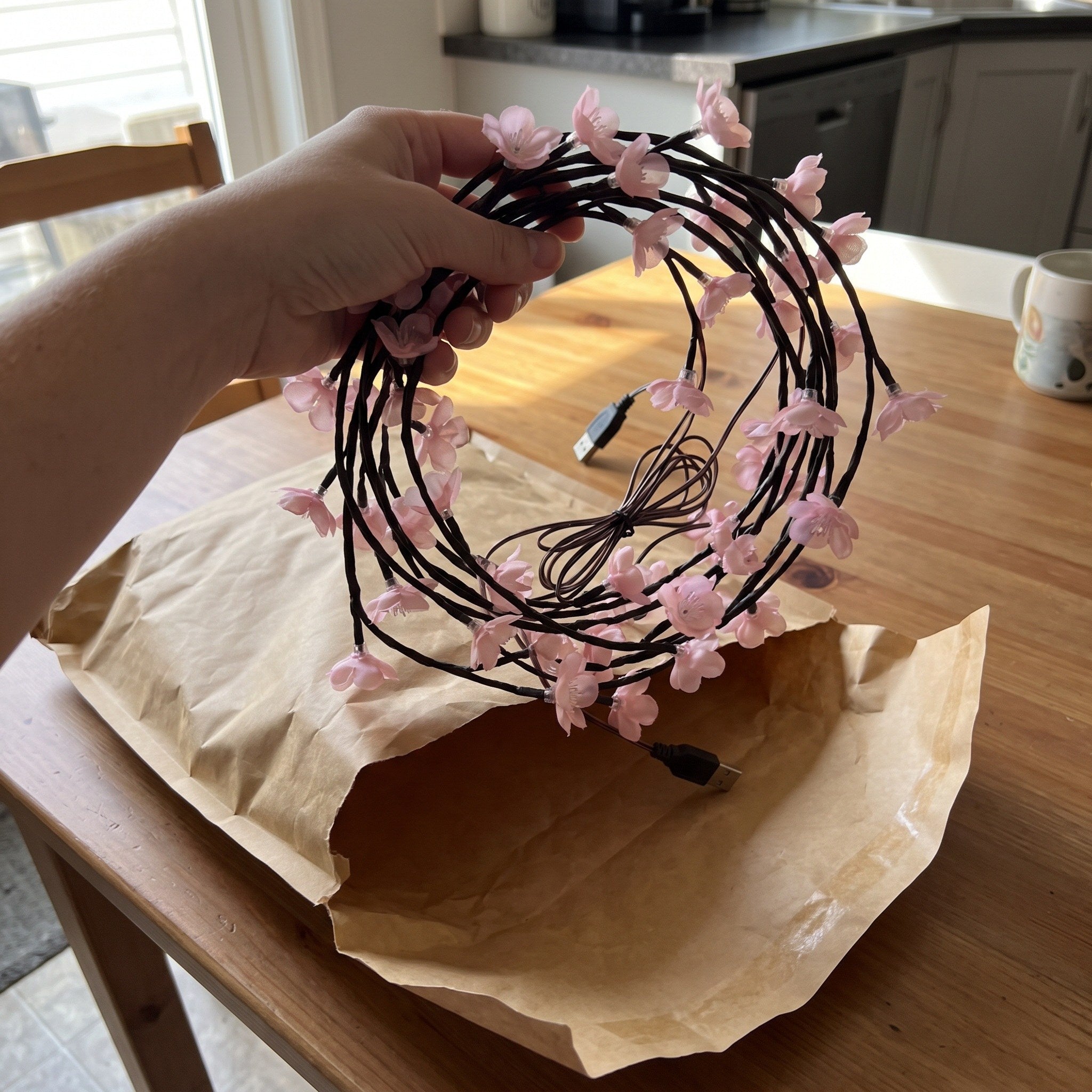 Pink blossom vine coiled beside a plain bag before use